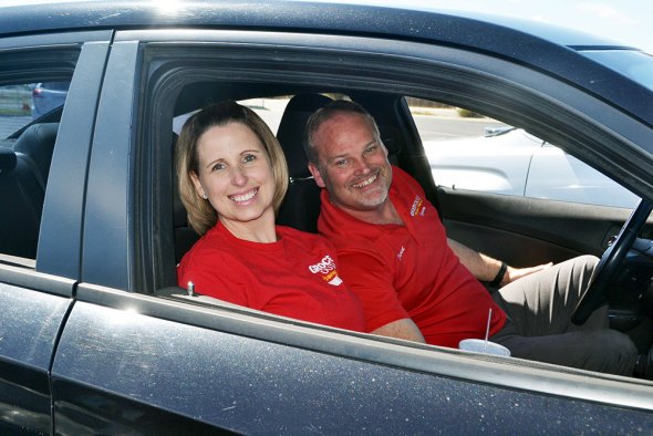 Karin and Dave McKinney enjoy their Beto's lunch from the confines of their car Friday afternoon.